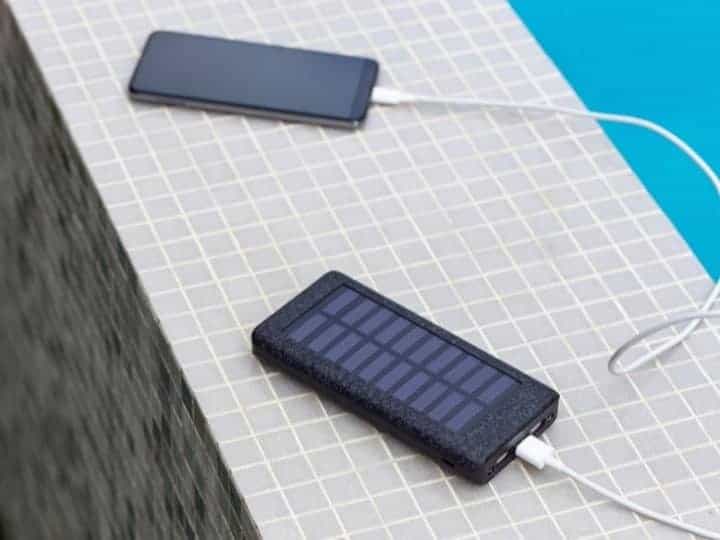 Solar Panel Charging a Phone by the Pool