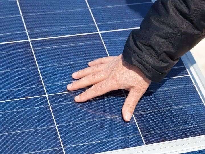 Solar Panel With a Hand on It