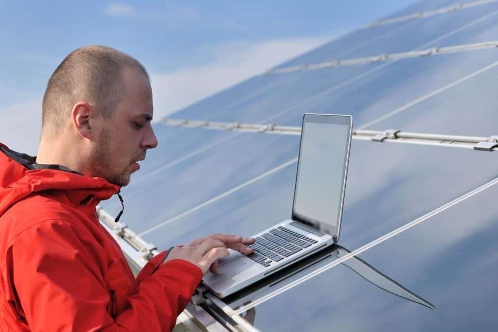 Man using a laptop on solar panels